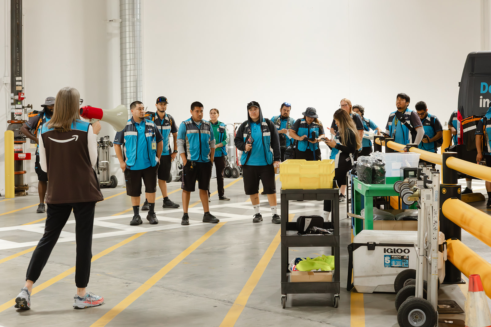 Holly addresses the Santosa Delivery team with a megaphone before routes go out.
